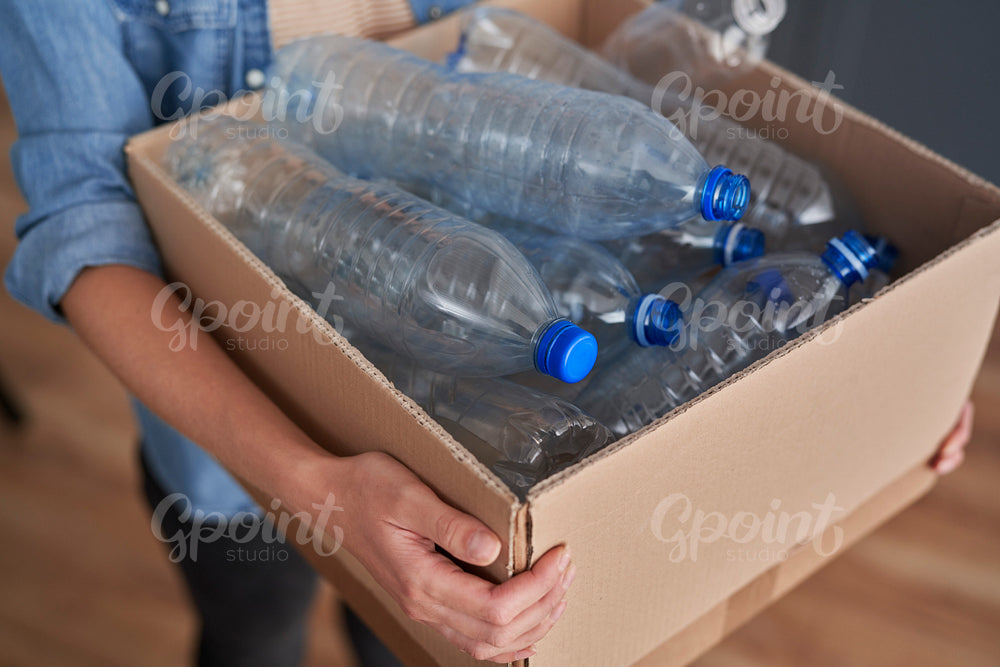 High angle view of paper box full of plastic bottles
