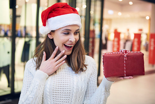 Excited woman looking at  Christmas present