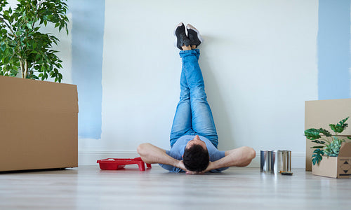 Rear view of man catching a break during moving house