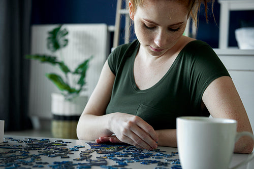 Bored woman over a puzzle game