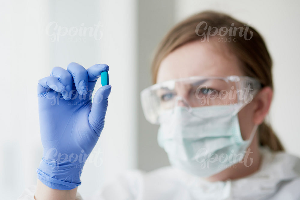 Capsule in hands of a laboratory technician