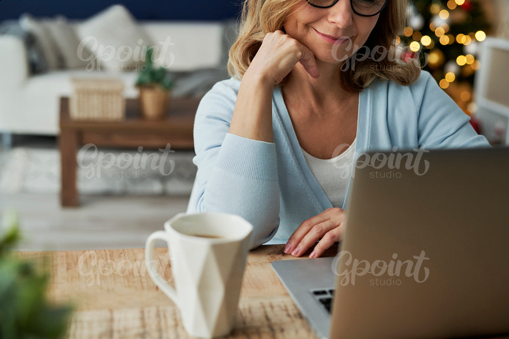 Close up of mature woman having video conference during Christmas