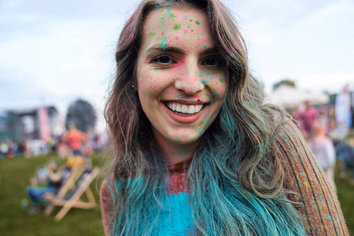 Smiling caucasian woman enjoying the colour powder festival