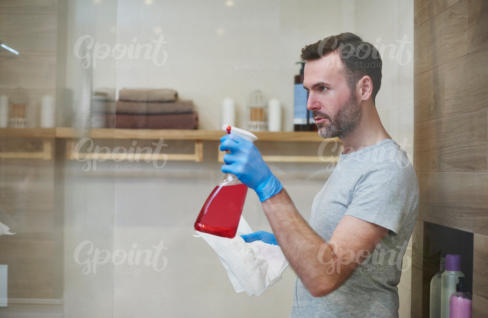 Side view of focused man cleaning