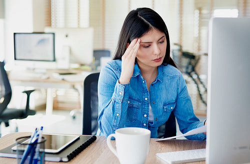 Woman concentrated on paper work in the office