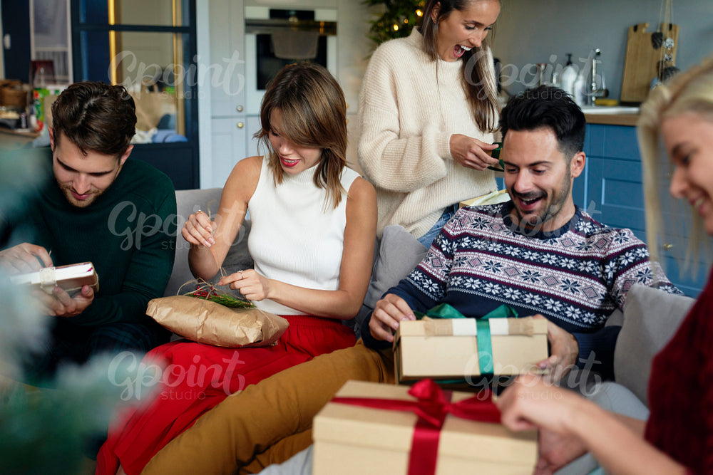 Friends opening received Christmas presents