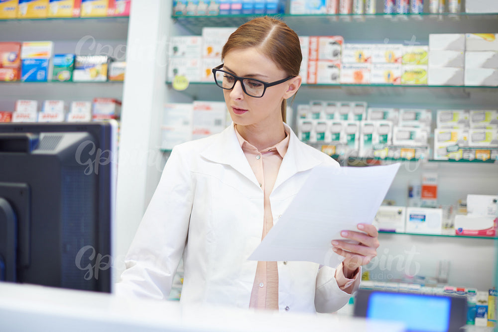 Front view of pharmacist working at drugstore