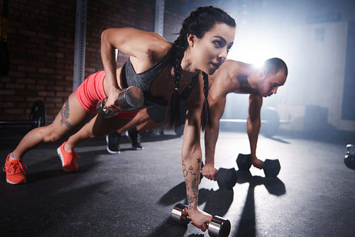 Athletes lifting weights and doing push ups