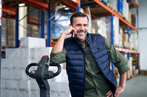 Portrait of caucasian man leaning on the forklift