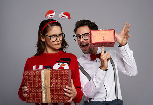 Funny couple with many Christmas gifts