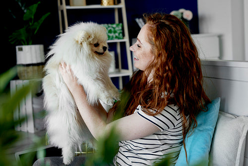 Woman holding  her cute fluffy pet dog