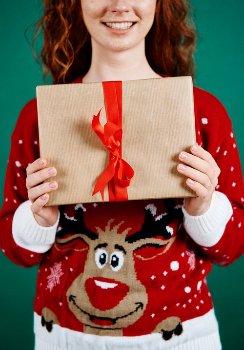 Close up of woman holding christmas present