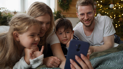 Family using smartphone during the Christmas