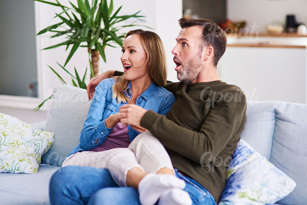 Scared couple watching horror movies