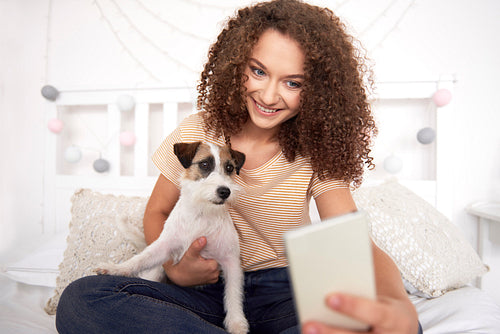 Teenage girl and her dog making a selfie