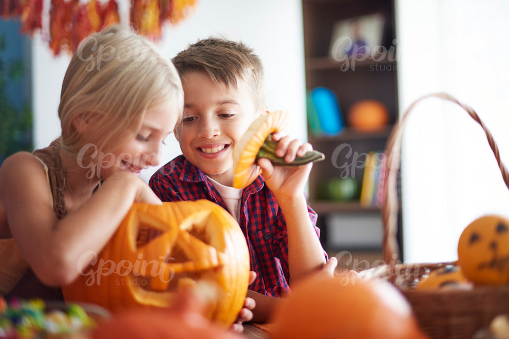 Children having fun with pumpkin