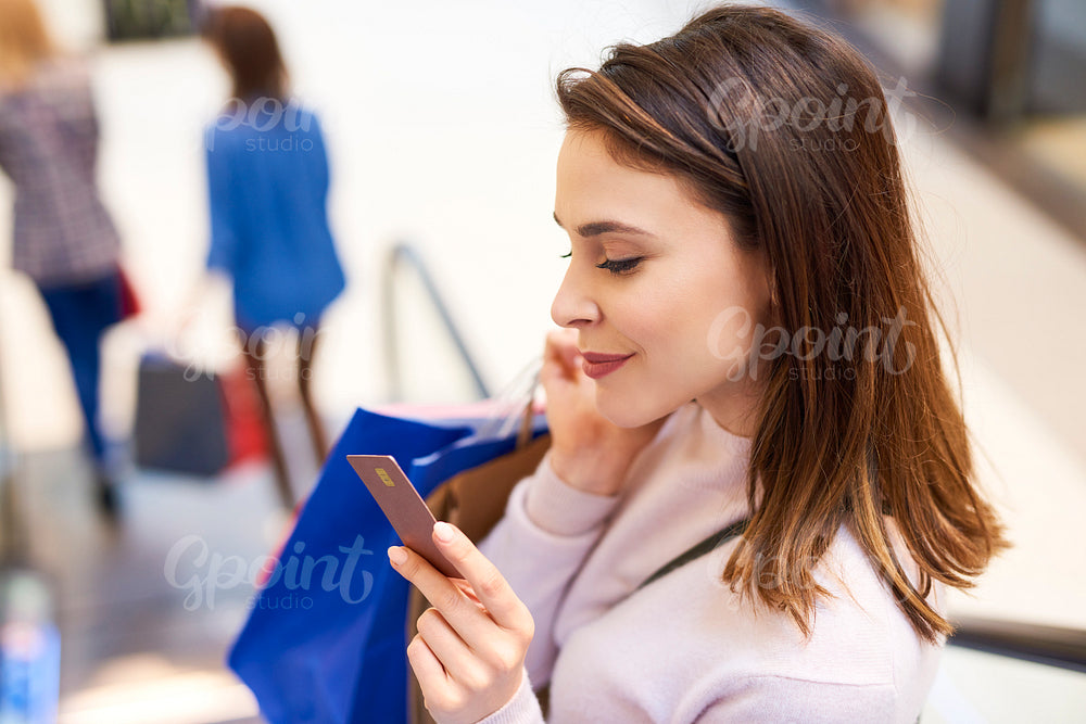 Woman with credit card during big shopping