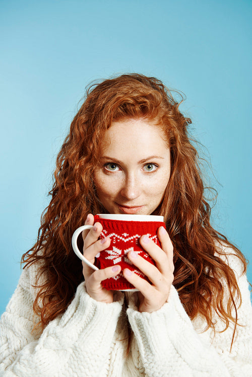 Portrait of smiling girl drinking hot tea