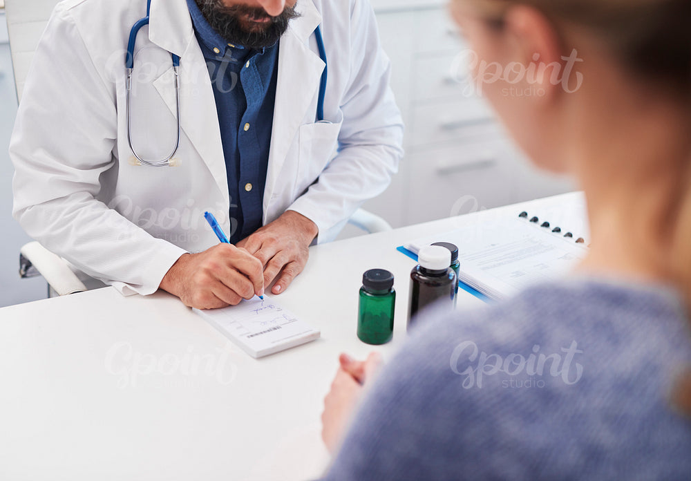 The doctor writes a prescription medicine to the patient.