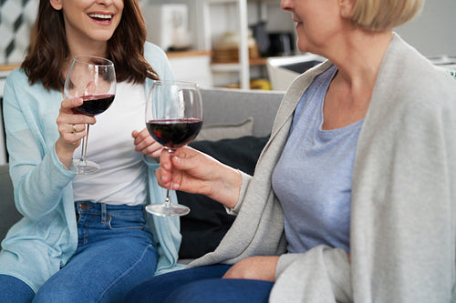 Close up of two woman drinking wine at home