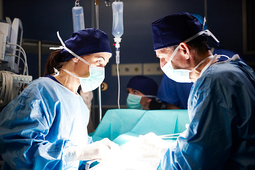 Team of surgeons working together in operating room