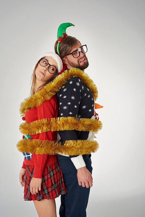 Couple wrapped in golden Christmas chain
