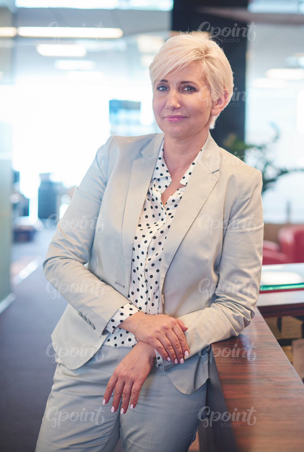 Portrait of blond senior woman in office