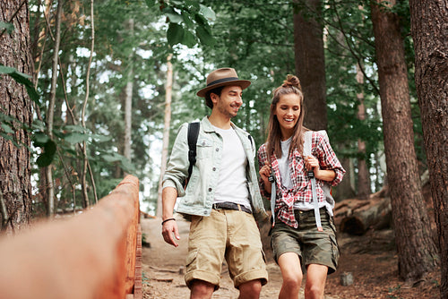 Young couple walking through forest