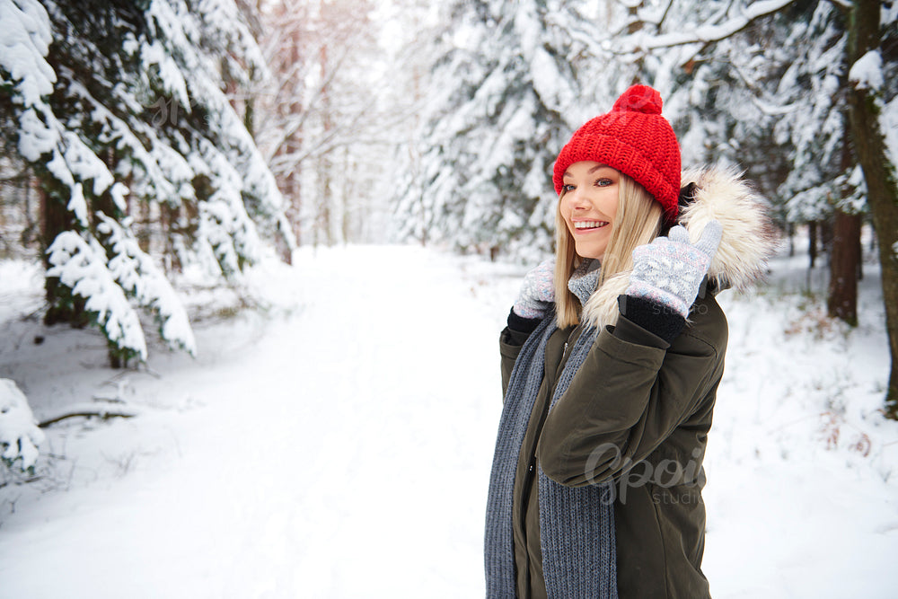 Smiling woman in winter forest