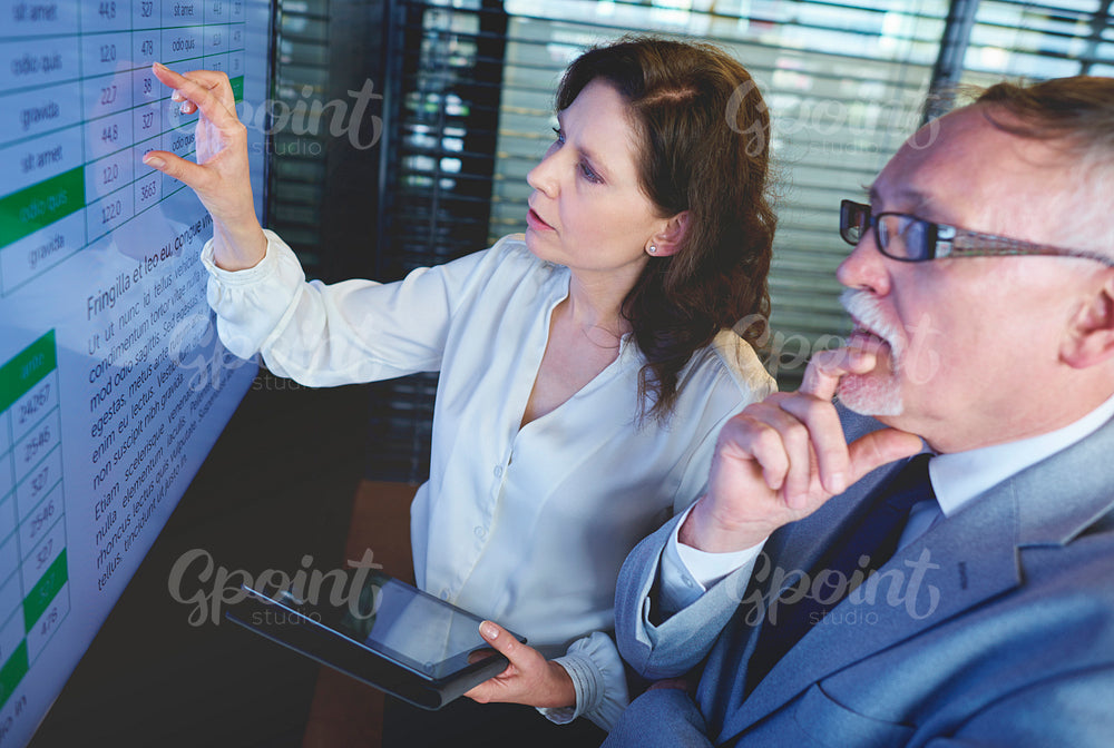 Business couple using screen in the meeting