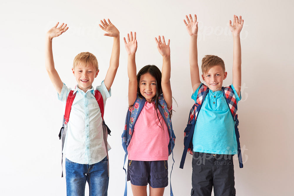 Children on white bakcground with hands up