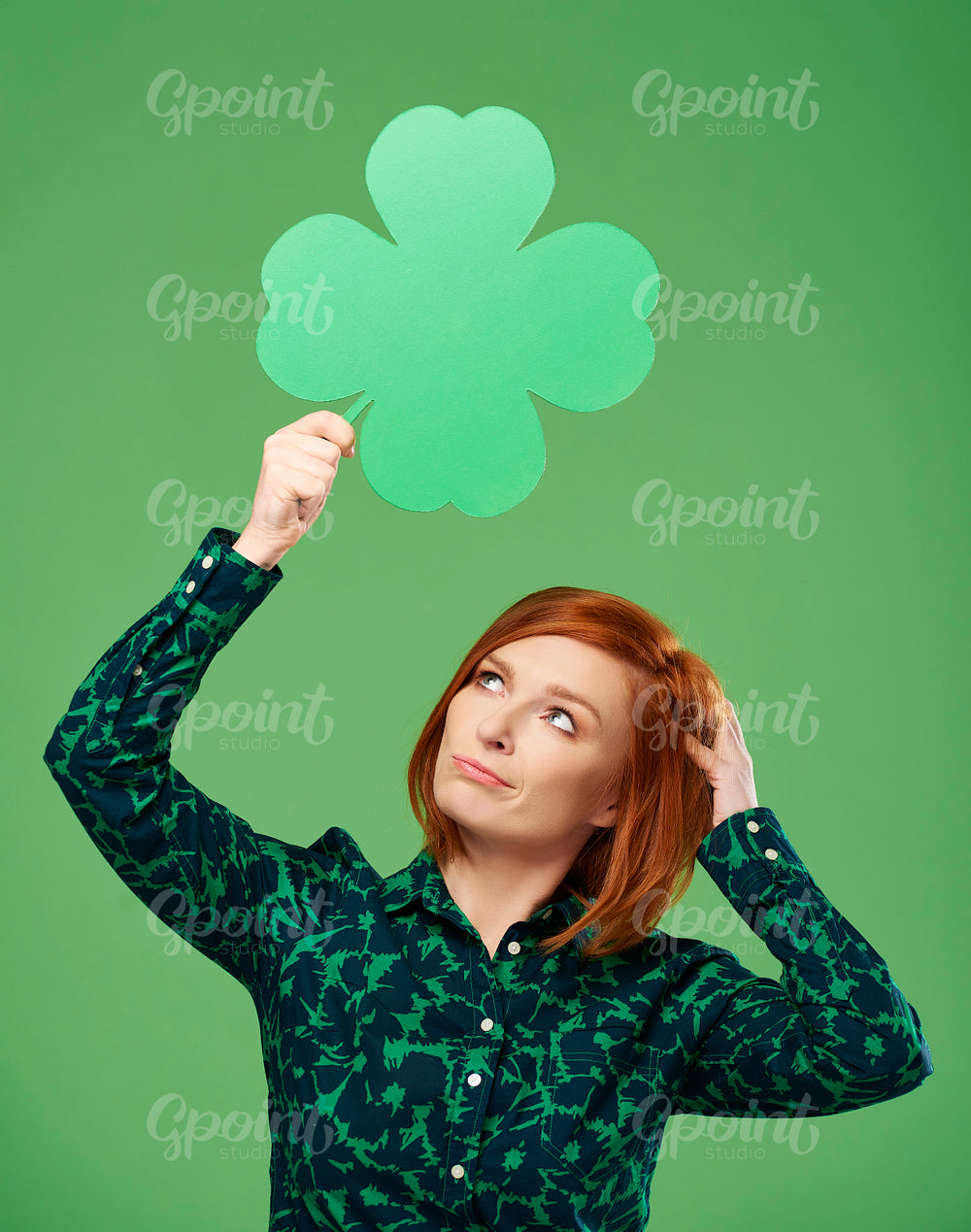 Woman looking at clover shaped banner with copy space