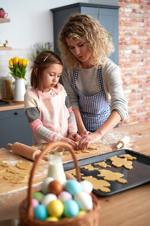 Daughter and mother  making Easter cookies at home