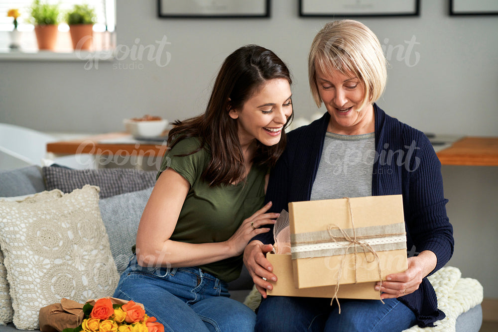 Mother unpacking a gift with her adult daughter