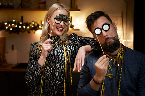 Couple have fun during making New Year's Eve photo booths