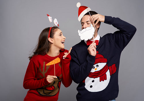 Studio shot of couple with funny Christmas gadgets