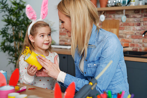 Mother and daughter preparing Easter decorations at home