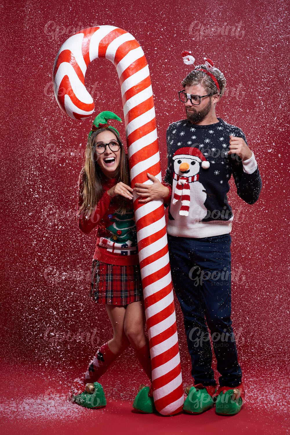 Couple standing next to the candy cane