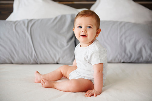 Portrait of charming baby girl on the bed