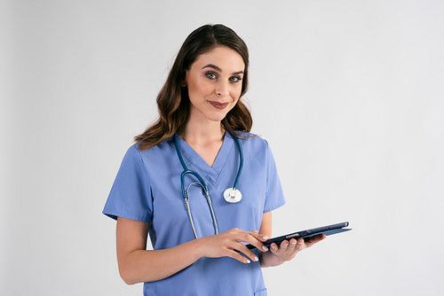 Portrait of smiling female nurse with tablet and stethoscope