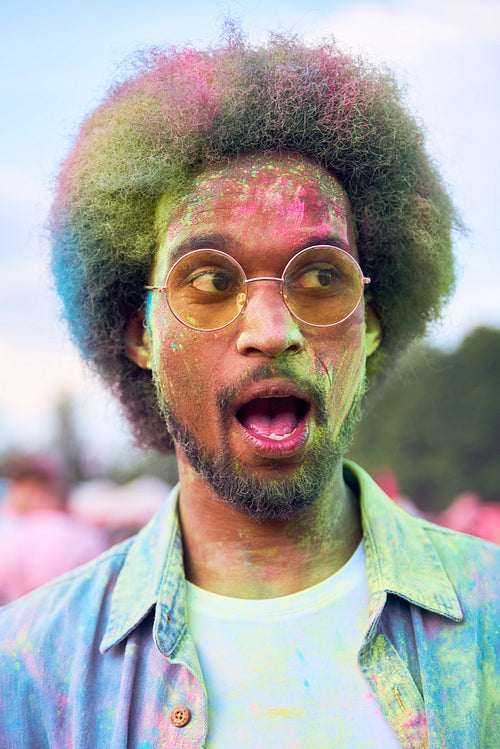 African man in holi colors at the summer festival
