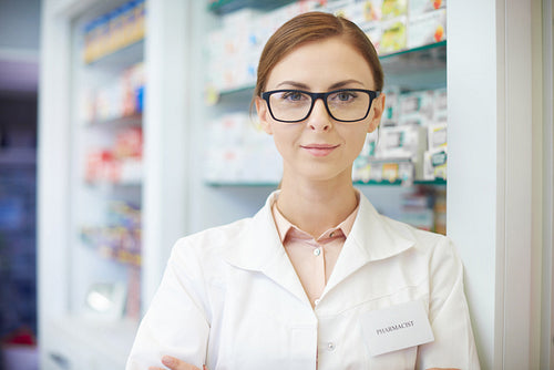 Young pharmacist standing in drug store