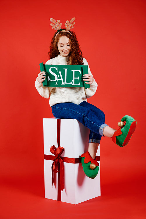 Young woman with banner of winter sale