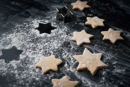 Close up of raw Christmas cookies on black background