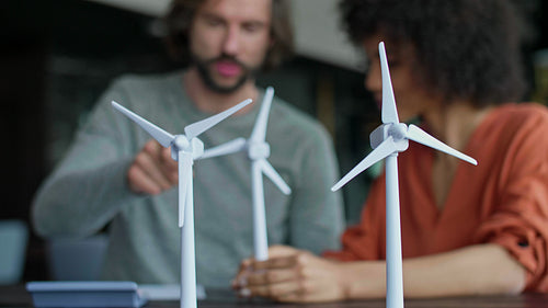 Two young engineers discuss wind turbine
