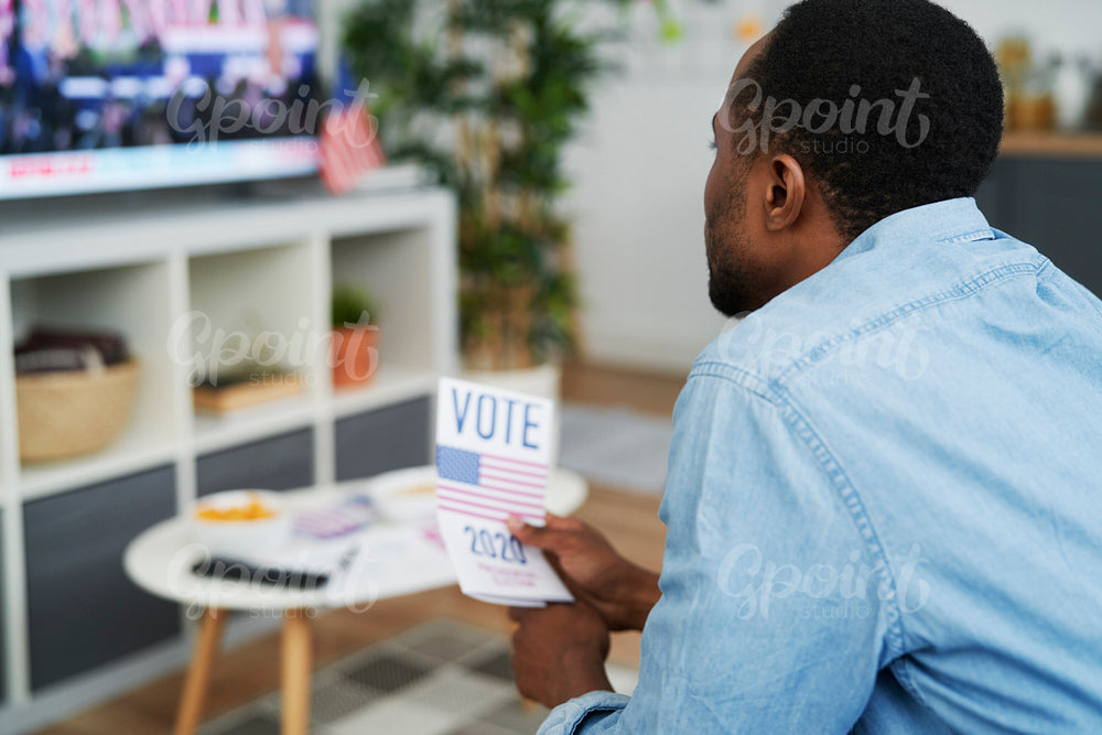 Close up of man interested in watching TV of election