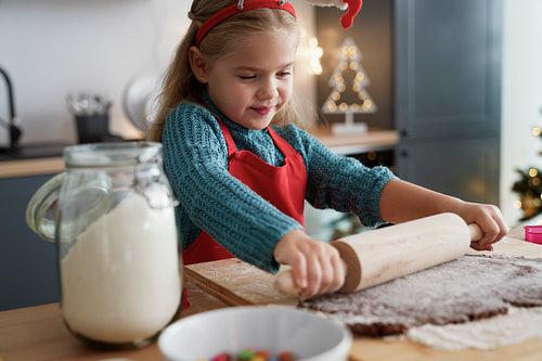 Girl focus on rolling gingerbread dough