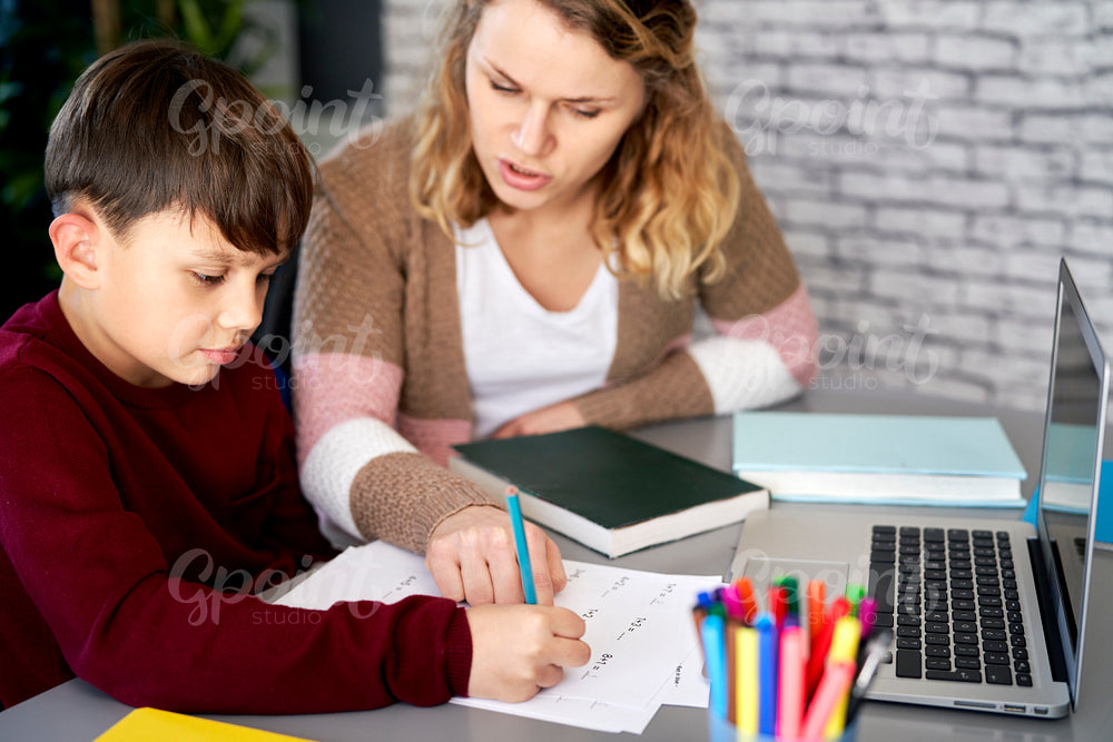 Mom explains to her son how to do the homework