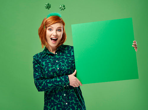 Portrait of screaming woman holding green banner with copy space