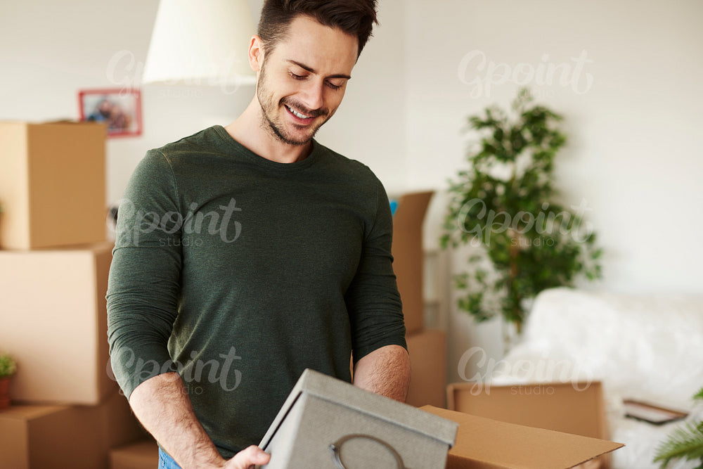 Close up of handsome man opening moving boxes